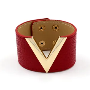 Wide red leather cuff bracelet with large golden metal V logo and snap closure design