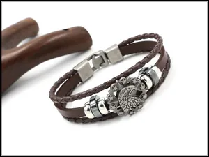 Detailed close-up of woven brown leather bracelet with embossed eagle and star metal charm