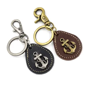 Vintage anchor leather keychains in black and brown with rustic metal nautical pendants