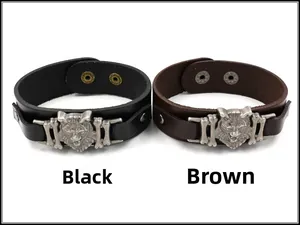 Detail view of adjustable black and brown leather bracelets with metal wolf head charms