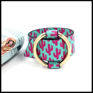 Detail view of teal faux leather bracelet with cactus print and round gold metal buckle