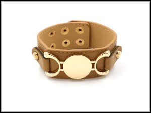 Close-up of tan leather bracelet with golden round metal plate and adjustable snaps