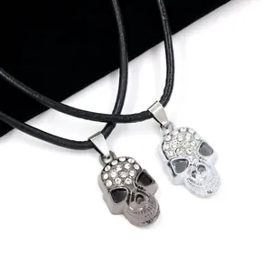 Punk style skull pendant necklaces with inlaid rhinestones on black cord in silver and black