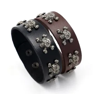 Punk style wide leather bracelets in black and brown with metal skull and crossbones studs