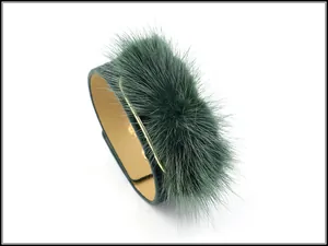 Detail of dark green PU leather bracelet featuring soft faux mink fur and gold button