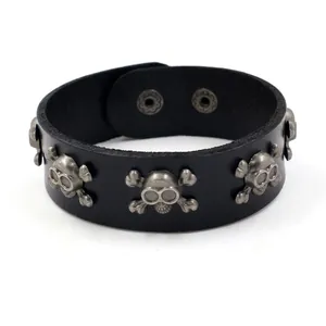 Punk black leather wide bracelet featuring vintage silver skull and crossbones studs