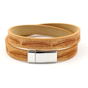 Detail eines hellbraunen Lederarmbands mit Federprägung und silbernem Magnetverschluss