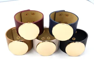 Close-up of wide PU leather bracelets with round gold metal plates in five colors