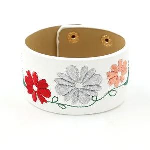 White PU leather wide cuff bracelet with colorful floral embroidery and gold snap buttons