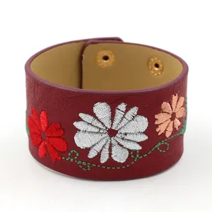 Ethnic wide PU leather cuff bracelet with colorful floral embroidery and gold snap buttons