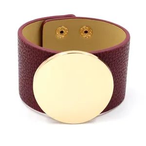 Wide burgundy leather cuff bracelet with large gold metal circle and snap buttons