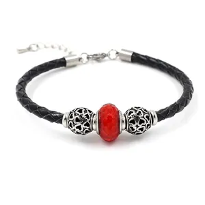 Braided leather bracelet with red crystal bead and silver heart-shaped metal charms