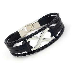Detailed macro view of infinity symbol on braided black leather bracelet for men