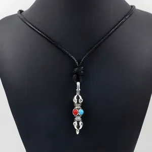 Ethnic style necklace with silver vajra pendant and red blue stones on black cord