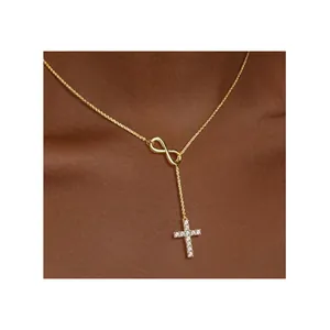 18K gold infinity cross lariat necklace featuring micro-set CZ stones on a Y-shaped chain