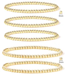 Detail of 5-piece stackable 18K gold bead bracelet set featuring 3mm and 4mm beads
