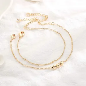 Detail of 18K gold-plated double-layer bead bracelet with lobster clasp and adjustable chain