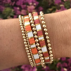 Set of 5 bohemian 18K gold-plated beaded bracelets with colorful Tila beads on a wrist
