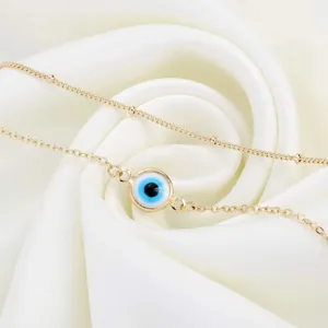 Double-layered 18K gold plated stainless steel bracelet with blue evil eye glass bead