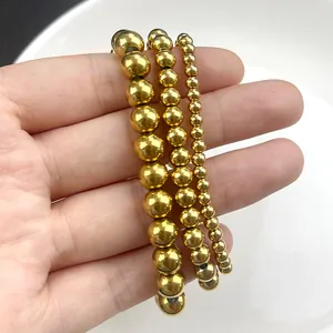 Detailed close-up of three 18K gold-plated stainless steel bead bracelets in varying sizes