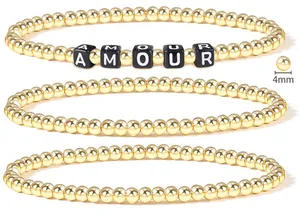Detail of 4mm 18K gold-plated beaded bracelet set with AMOUR letter charm cubes