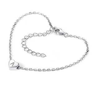 Macro shot of silver stainless steel heart charm bracelet with engraved letter A