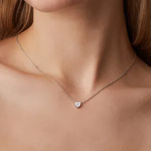 Detailed view of an 18K gold plated heart pendant with an engraved letter S on the necklace