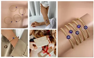 Detail of multi-layered gold beaded bracelets with blue evil eye charm in a lifestyle set