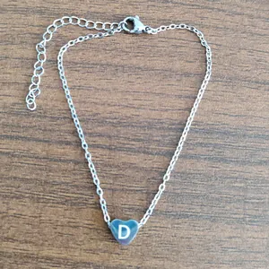 Delicate stainless steel chain bracelet with a heart pendant featuring the letter D