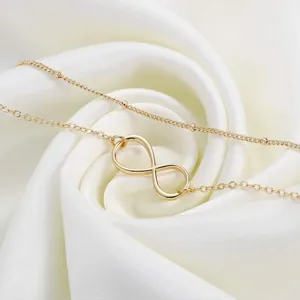 Close-up of 18K gold stainless steel double chain with infinity symbol and beads