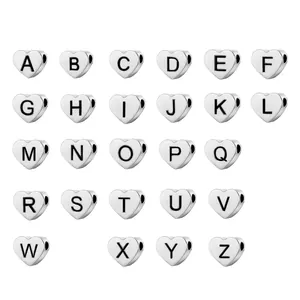 Macro shot of 26 heart-shaped stainless steel alphabet beads for DIY jewelry making