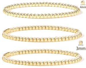 Detail view of 3mm and 4mm 18K gold plated stainless steel beaded bracelets set