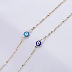 Golden evil eye pendant necklace in blue and dark blue with a fine link chain style