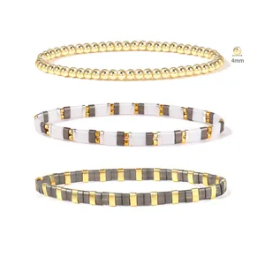 Detail of 4mm golden round beads and colorful enamel tile stretch bracelets combination