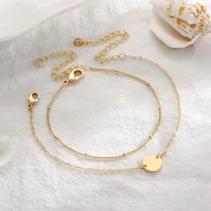 Double-layered 18K gold plated bead chain bracelet with a polished round disc charm