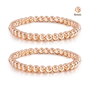 Detail view of 4mm rose gold beaded stretch bracelets with polished mirror finish
