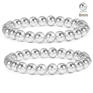 Macro view of two 8mm silver stainless steel beaded bracelets with mirror polish