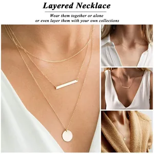 Detailed view of layered 18K gold plated stainless steel necklaces with disc and bar pendants