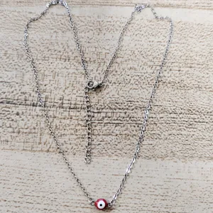 Macro shot of silver-plated evil eye necklace with lobster clasp and adjustable chain