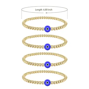 Detailed view of 4-piece gold bead bracelets with blue evil eye charms and 6.8 inch length