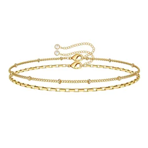 Detail of 18K gold stainless steel layered satellite and flat link chain with crystal