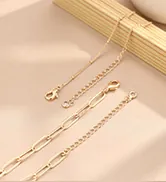 Close-up of gold stainless steel paperclip and bead chain with lobster clasp detail
