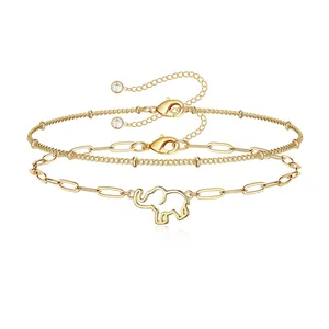 Detail of 18K gold stainless steel layered bracelets featuring elephant charm and beads