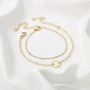 Detail of 18K gold-plated double-layer bracelet with hammered coin and bead chains