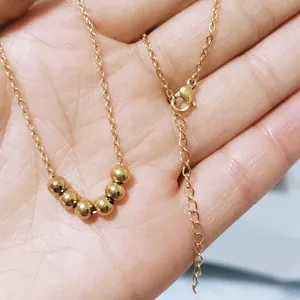 Minimalist 18K gold plated stainless steel necklace with six sliding beads on a cable chain