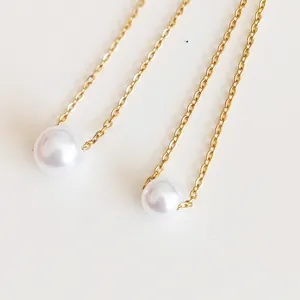 Close-up of minimalist 18K gold-plated stainless steel chain with round white pearl