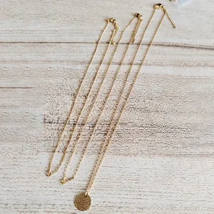 Three-piece layered 18K gold plated stainless steel necklace set with round disc pendant