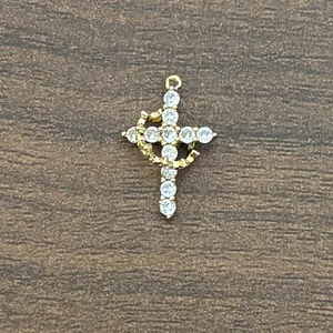 18K gold plated brass cross pendant with 3A cubic zirconia and a golden ring orbit