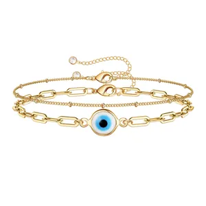 Gelaagde 18K gouden paperclip armband met blauwe Evil Eye hanger en zirkonia