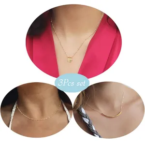 Three-piece gold plated layered necklace set with round coins and curved tube pendants
